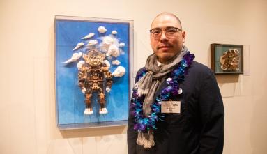 sean chao in front of his artwork